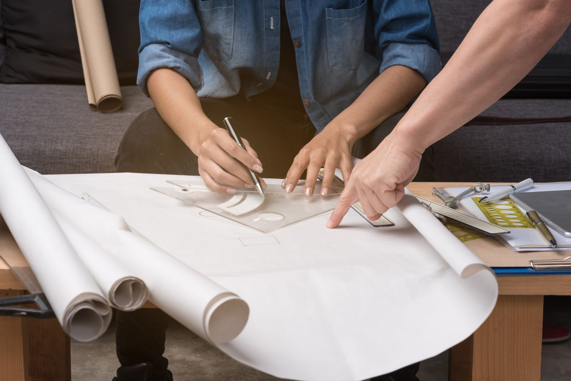 Business woman engineer in working time.The team's hand point to drawing paper during meeting, Busy and work hard.  Business woman engineer in working time.The team's hand point to drawing paper during meeting, Busy and work hard.